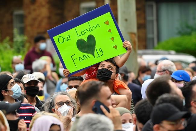 People wait for a vigil to begin outside the London Muslim Mosque for the victims of the deadly vehicle attack on five members of the Canadian Muslim community in London, Ont., on Tuesday, June 8, 2021. Four of the members of the family died and one is in critical condition. Police have charged a London man with four counts of murder and one count of attempted murder. THE CANADIAN PRESS/Nathan Denette