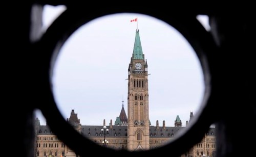 The Parliament Hill Peace Tower is framed in an iron fence on Wellington Street in Ottawa on Thursday, March 12, 2020. After weeks of virtual hearings and often heated debate, an extensively amended Bill C-10 will go back to the House of Commons for a final vote. THE CANADIAN PRESS/Sean Kilpatrick