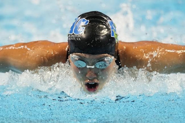 Torri Huske participates in the Women's 100 Butterfly during wave 2 of the U.S. Olympic Swim Trials on Sunday, June 13, 2021, in Omaha, Neb. (AP Photo/Charlie Neibergall)
