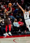 Portland Trail Blazers guard Damian Lillard shoots a 3-point basket over Denver Nuggets forward Michael Porter Jr. during the first half of Game 6 of an NBA basketball first-round playoff series Thursday, June 3, 2021, in Portland, Ore. (AP Photo/Craig Mitchelldyer)