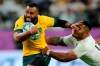 FILE - In this Oct. 19, 2019 file photo, Australia's Samu Kerevi fends off an England's Manu Tuilagi during the Rugby World Cup quarterfinal match at Oita Stadium in Oita, Japan. Kerevi has been named in the Australian 7's squad for the Tokyo Olympics. (AP Photo/Christophe Ena,File)