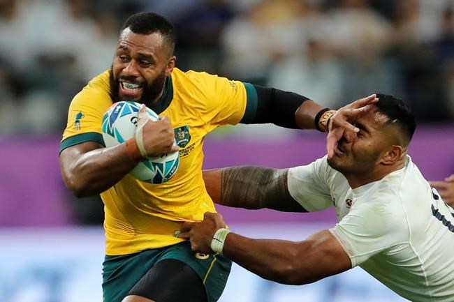 FILE - In this Oct. 19, 2019 file photo, Australia's Samu Kerevi fends off an England's Manu Tuilagi during the Rugby World Cup quarterfinal match at Oita Stadium in Oita, Japan. Kerevi has been named in the Australian 7's squad for the Tokyo Olympics. (AP Photo/Christophe Ena,File)