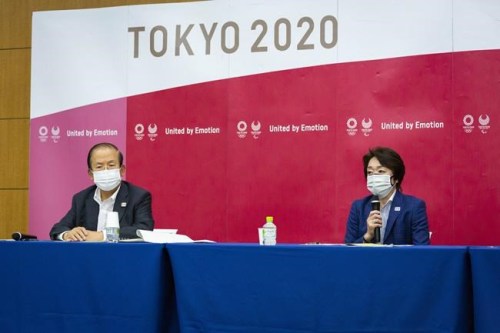 Tokyo 2020 CEO Toshiro Muto, left, and President Seiko Hashimoto attend the news conference after receiving a report from a group of infectious disease experts on Friday, June 18, 2021, in Tokyo. The experts including Shigeru Omi, head of a government coronavirus advisory panel, issued a report listing the risks of allowing the spectators and the measurements to prevent the event from triggering a coronavirus spread. (Yuichi Yamazaki/Pool Photo via AP)