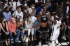 Fans watch as Milwaukee Bucks' Jrue Holiday (21) defends against Brooklyn Nets' James Harden (13) during the first half of Game 7 of a second-round NBA basketball playoff series Saturday, June 19, 2021, in New York. (AP Photo/Frank Franklin II)