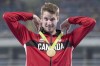 Canada's Derek Drouin adjusts his gold medal for high jump at the Olympic games in Rio de Janeiro, Brazil, Wednesday August 17, 2016. THE CANADIAN PRESS/Frank Gunn