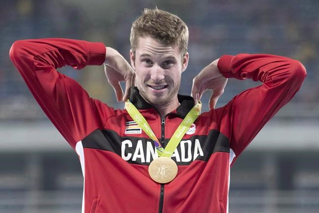 Canada's Derek Drouin adjusts his gold medal for high jump at the Olympic games in Rio de Janeiro, Brazil, Wednesday August 17, 2016. THE CANADIAN PRESS/Frank Gunn