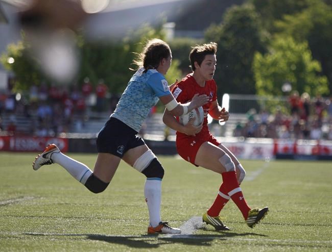Team Canada's Ghislaine Landry holds off a Team Russia player during action at the HSBC Canada Women's Sevens at Westhills Stadium in Langford, B.C., on Saturday, May 27, 2017. THE CANADIAN PRESS/Chad Hipolito