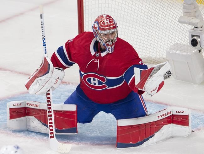 Montreal Canadiens goaltender Carey Price (31) makes a glove save during first period NHL Stanley Cup playoff hockey action against the Winnipeg Jets, in Montreal, Sunday, June 6, 2021. THE CANADIAN PRESS/Ryan Remiorz