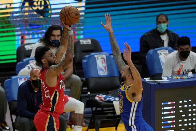 New Orleans Pelicans guard Nickeil Alexander-Walker (6) takes a three-point shot over Golden State Warriors guard Mychal Mulder (15) during the first half of an NBA basketball game on Friday, May 14, 2021, in San Francisco. THE CANADIAN PRESS/AP-Tony Avelar