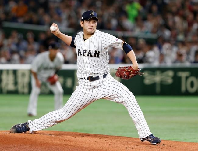 FILE - In this March 14, 2017, file photo, Japan starting pitcher Tomoyuki Sugano throws to a Cuba batter during the first inning of a second-round game at the World Baseball Classic in Tokyo. Host Japan is favored to win at the Tokyo Games. . Right-hander Tomoyuki Sugano, the reigning Central League MVP, heads a pitching staff that includes current Rookies of the Year Masato Morishita and Kaima Taira. (AP Photo/Toru Takahashi, File)