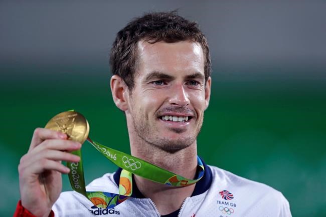 FILE - Andy Murray, of England, smiles as he holds up his gold medal at the 2016 Summer Olympics in Rio de Janeiro, Brazil, in this Sunday, Aug. 14, 2016, file photo. Murray's been through two hip operations and assorted other injuries since he became the first tennis player with multiple Olympic singles golds by winning in 2012 and 2016. His ranking outside the Top 100, but past success — including three Grand Slam trophies — earned him a special spot in the Tokyo field for Britain. “I just hope,” he said, “the body holds up.”(AP Photo/Charles Krupa, File)
