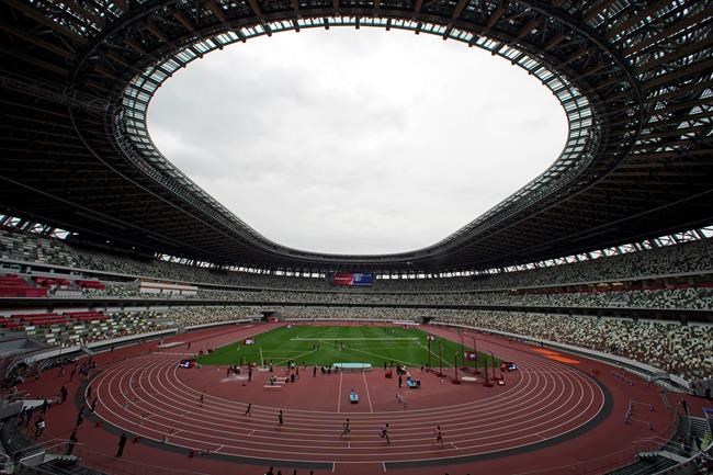 In this May 11, 2021, file photo, athletes compete in the men's 400-meter T20 race during an athletics test event for the Tokyo 2020 Paralympics Games at National Stadium in Tokyo. The pandemic-delayed Tokyo Olympics are shaping up as a TV-only event with few fans — if any — being allowed when they open in just over two weeks. Japan's Asahi newspaper, citing multiple unidentified government sources, says the opening ceremony will be limited only to VIP guests. (AP Photo/Shuji Kajiyama, File)
