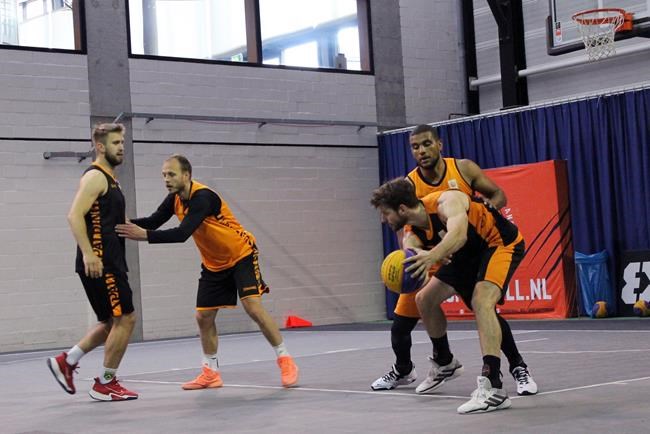 Julian Jaring, right, protects the ball from Dimeo van der Horst, backgrouund right, as Aron Roije defends Deividas Kumelis, left during a Netherlands 3x3 basketball team practice at a court in Amsterdam, Tuesday June 22, 2021 in preparation for the Tokyo Olympics. Three-on-three basketball debuts as an Olympic sport in Tokyo and presents traditionally overlooked basketball countries with opportunities for medals. (AP Photo/Kenneth Maguire)