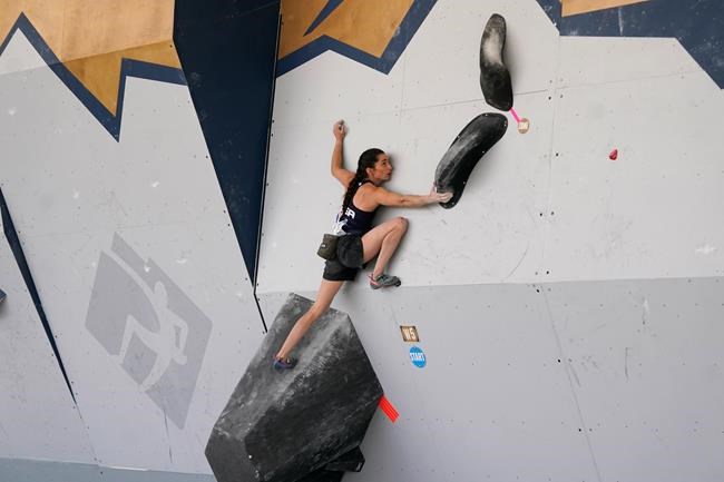 FILE - United States' Kyra Condie climbs during women's boulder qualifications at the climbing World Cup in Salt Lake City, in this May 21, 2021, file photo. Condie was told she needed back surgery to fix a severe curvature in her spine and would never be able to climb again. She did have surgery, after getting a second opinion, and has willed herself into becoming one of the world’s elite climbers despite having 10 vertebrae fused together. (AP Photo/Rick Bowmer, File)