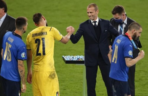 President of UEFA Aleksander Ceferin congratulates Italy's goalkeeper Gianluigi Donnarumma after they defeated England on the Euro 2020 soccer championship final at Wembley stadium in London, Sunday, July 11, 2021. (John Sibley/Pool Photo via AP)