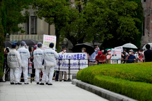 Protesters gather before International Olympic Committee President Thomas Bach visits Hiroshima Memorial Cenotaph Friday, July 16, 2021, in Hiroshima, western Japan. (AP Photo/Eugene Hoshiko, Pool)