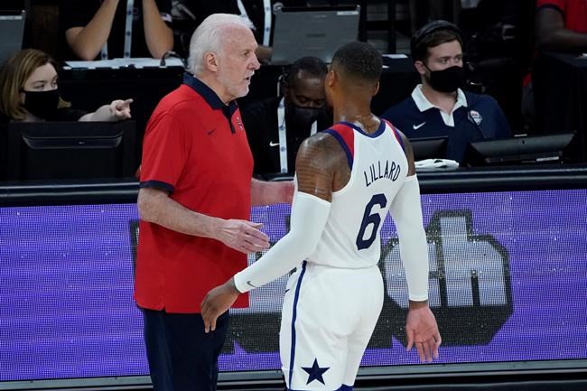 United States head coach Gregg Popovich speaks with Damian Lillard (6) during the first half of an exhibition basketball game against Spain in preparation for the Olympics, Sunday, July 18, 2021, in Las Vegas. (AP Photo/John Locher)