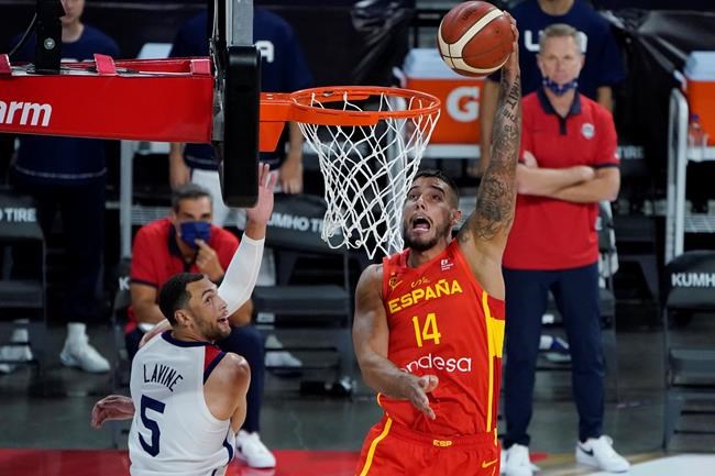 Spain's Willy Hernangomez (14) dunks against United States' Zachary Lavine (5) during the second half of an exhibition basketball game in preparation for the Olympics, Sunday, July 18, 2021, in Las Vegas. (AP Photo/John Locher)