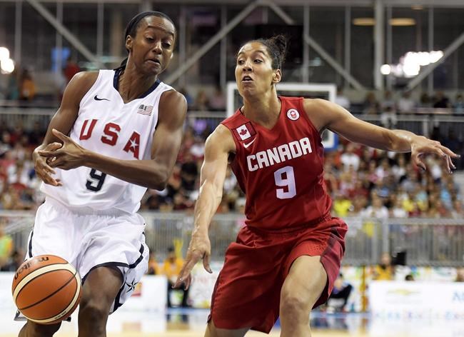Canada forward Miranda Ayim battles for the ball against United States guard Shatori Walker (9) during first half gold medal action at the Pan American Games in Toronto on Monday, July 20, 2015. Women's basketball player Miranda Ayim and men’s rugby sevens player Nathan Hirayama have been named Canada's flag-bearers for the opening ceremony of the Tokyo Olympics. THE CANADIAN PRESS/Nathan Denette