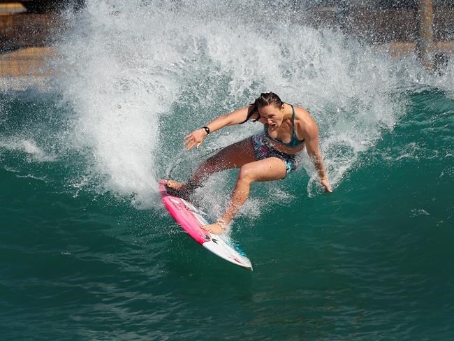 Surfer Carissa Moore of the United States works out on a Surf Ranch wave during practice rounds for the upcoming Olympics Yuesday, June 15, 2021, in Lemoore, Calif. Moore is headed to the Olympics for surfing's debut at the Games, Though there's much excitement and renewed enthusiasm for the women's game, the objectification, pay disparities and opportunity gap have taken its toll. Industry leaders say they're committed to righting the wrongs that have long held female surfers back in the male-dominated sport. The mental, financial and logistical roadblocks for women in surfing date back centuries. (AP Photo/Gary Kazanjian)