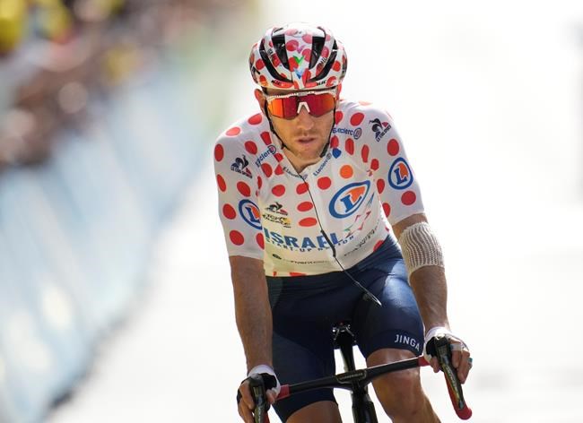 Michael Woods of Canada crosses the finish line after losing his best climber's dotted jersey to Netherland's Wouter Poels during the fifteenth stage of the Tour de France cycling race with the start in Ceret and finish in Andorra-la-Vella, Andorra, Sunday, July 11, 2021. THE CANADIAN PRESS/AP/Christophe Ena