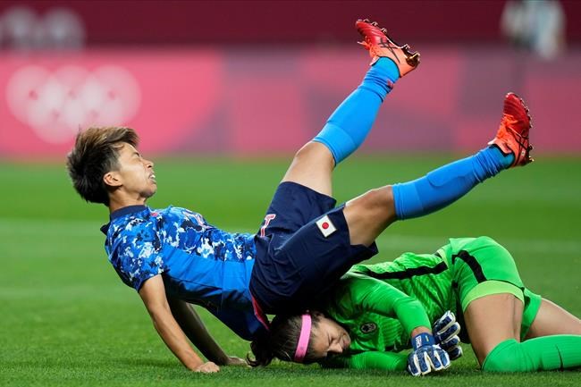 Japan's Mina Tanaka (11) collides with Canada's goalkeeper Stephanie Labbe (1) during a women's soccer match at the 2020 Summer Olympics, Wednesday, July 21, 2021, in Sapporo, Japan. THE CANADIAN PRESS/AP/Silvia Izquierdo
