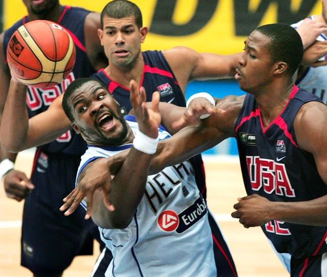 FILE - In this Sep. 1, 2006, file photo, Greece's Sofoklis Schortsiantis, left, drives to the basket as USA's Dwight Howard (12), right, NBA's Orlando Magic, and Shane Battier, of NBA's Memphis Grizzlies, ceneter back, guard during the semifinals of the World Basketball Championships in Saitama, Japan. The 2006 world championship was perhaps the last truly wide-open international basketball event. Argentina arrived as the Olympic champion and Spain left as the world champion, the last time for a long while anyone other than the U.S. would hold either title. (AP Photo/Itsuo Inouye, File)