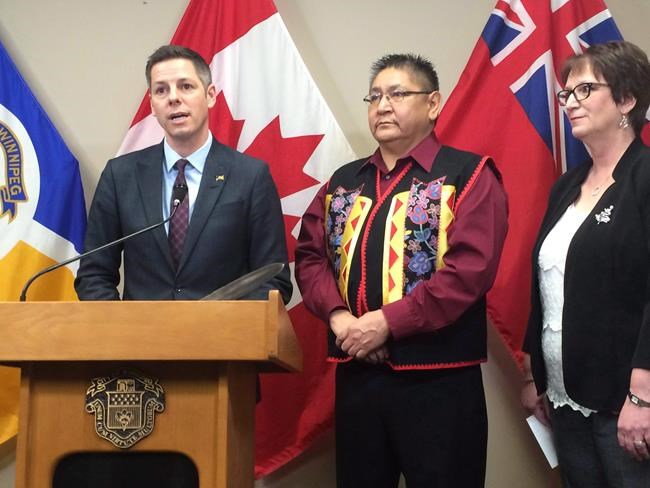 Winnipeg Mayor Brian Bowman, Shoal Lake 40 First Nation Chief Erwin Redsky and Manitoba Indigenous Affairs Minister Eileen Clarke speak to reporters at Winnipeg city hall Monday about an agreement to build a road to Shoal Lake 40, an isolated reserve near the Manitoba-Ontario boundary on Monday Dec. 12, 2016. THE CANADIAN PRESS/Steve Lambert