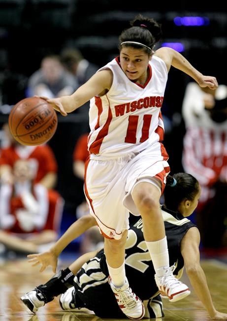FILE - In this Friday, March 5, 2010 file photo, Wisconsin guard Rae Lin D'Alie, front, make steals the basketball from Purdue guard KK Houser during the first half of an NCAA college basketball game in the second round of the Women's Big Ten NCAA conference tournament in Indianapolis. Rae Lin D'Alie was born and raised in Wisconsin but is the star of Italy's 3-on-3 basketball team at the Tokyo Olympics. “Rae Rae” as she is known usually is the shortest player on the court at 5-foot-3 but is Italy's spark plug and court general. (AP Photo/Darron Cummings, File)
