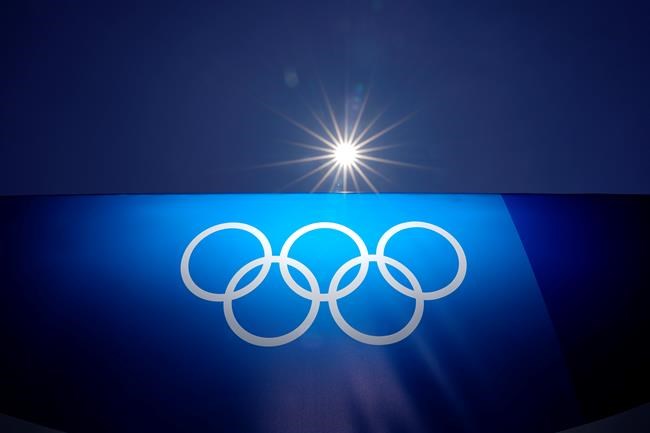 The sun shines above an image of the Olympic rings at Yokohama Baseball Stadium as the venue is prepared for softball competition at the 2020 Summer Olympics, Thursday, July 22, 2021, in Yokohama, Japan. (AP Photo/Matt Slocum)