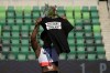 FILE - In this June 26, 2021, file photo, Gwendolyn Berry her Activist Athlete T-shirt over her head during the metal ceremony after the finals of the women's hammer throw at the U.S. Olympic Track and Field Trials in Eugene, Ore. Tommie Smith, John Carlos and Berry are among the more than 150 educators, activists and athletes who signed a letter Thursday, July 22, urging the IOC not to punish participants who demonstrate at the Tokyo Games. (AP Photo/Charlie Riedel, File)