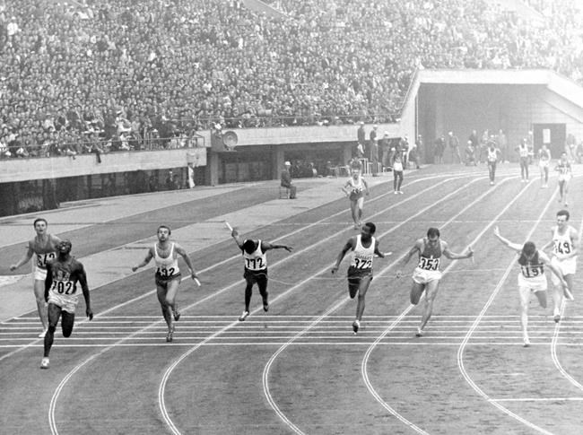 This Oct. 21, 1964, file photo shows the finish scene of men's 4 x100 meter relay finals at the National Stadium in Tokyo. From left are B. Savchuk, of Soviet Union, Bob Hayes, of U.S., winner, M. Dudzuak, of Poland, second, H. Herrerfa Fucil, of Venezuela, D.O. Johnson, of Jamaica, P. Gionnattasio, of Italy, J. Delecour, of France, third, and L. Davies of Britain. (AP Photo, File)