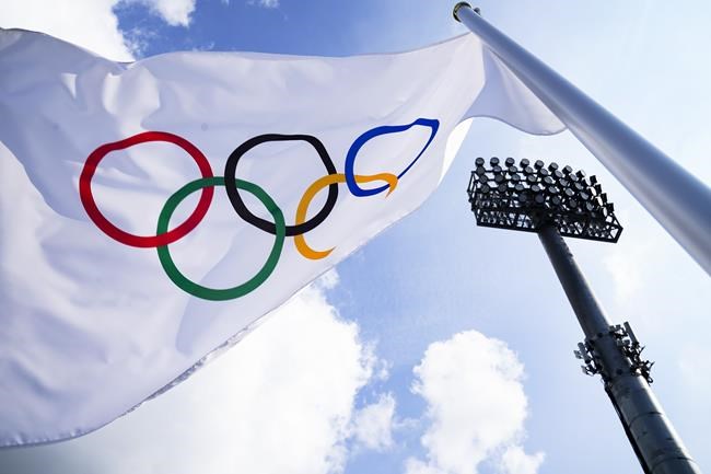 A flag bearing the Olympic Rings is displayed on the south pitch during field hockey practices at the 2020 Summer Olympics, Friday, July 23, 2021, in Tokyo, Japan. (AP Photo/John Minchillo)