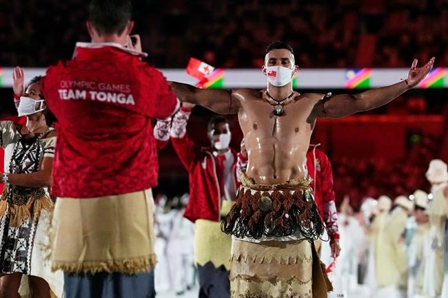 Pita Taufatofua, of Tonga, walks during the opening ceremony in the Olympic Stadium at the 2020 Summer Olympics, Friday, July 23, 2021, in Tokyo, Japan. (AP Photo/Petr David Josek)