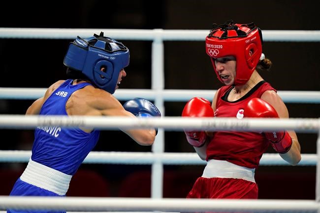 Canada's Mandy Bujold, right, exchanges punches with Serbia's Nina Radovanovic during their women's flyweight 51-kg boxing match at the 2020 Summer Olympics, Saturday, July 24, 2021, in Tokyo, Japan. (AP Photo/Frank Franklin II)