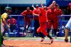United States' Haylie McCleney scores the game winning run in front of Australia's Belinda White, left, in the eighth inning of a softball game at the 2020 Summer Olympics, Sunday, July 25, 2021, in Yokohama, Japan. (AP Photo/Sue Ogrocki)