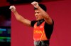 Li Fabin of China celebrates after a lift as he competes in the men's 61kg weightlifting event, at the 2020 Summer Olympics, Sunday, July 25, 2021, in Tokyo, Japan. (AP Photo/Luca Bruno)