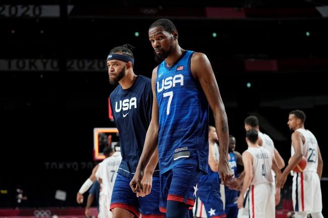 United States' Javale Mc Gee, left, and forward Kevin Durant (7) walk off the court after their loss to France in a men's basketball preliminary round game at the 2020 Summer Olympics, Sunday, July 25, 2021, in Saitama, Japan. (AP Photo/Eric Gay)