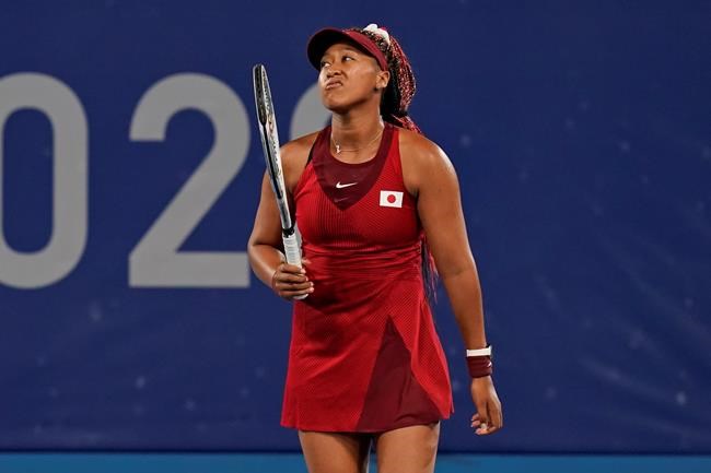 Naomi Osaka, of Japan, reacts after losing a point to Marketa Vondrousova, of the Czech Republic, during the third round of the tennis competition at the 2020 Summer Olympics, Tuesday, July 27, 2021, in Tokyo, Japan. (AP Photo/Seth Wenig)