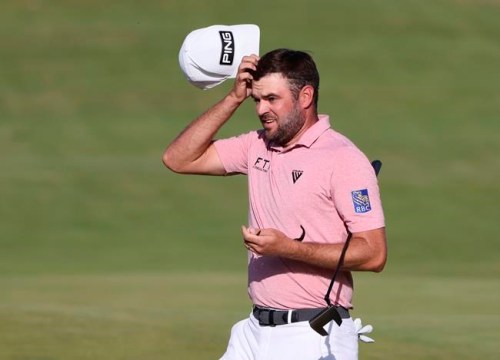 Canada's Corey Conners acknowledges the crowd as her completes his third round on the 18th green at the British Open Golf Championship at Royal St George's golf course Sandwich, England, Saturday, July 17, 2021. THE CANADIAN PRESS/AP/Ian Walton