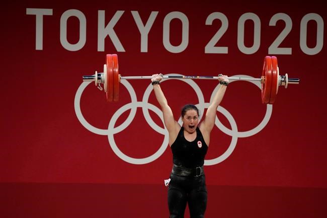 Maude G. Charron of Canada celebrates after a lift in the women's 64kg weightlifting event, at the 2020 Summer Olympics, Tuesday, July 27, 2021, in Tokyo, Japan. THE CANADIAN PRESS/AP/Luca Bruno