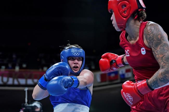 Canada's Tammara Thibeault, right, and Kazakhstan's Nadezhda Ryabets exchange punches during the women's middleweight boxing match at the Tokyo Summer Olympic Games, in Tokyo, Wednesday, July 28, 2021. Thibeault's Olympic quest will continue after the 24-year-old won the bout by split decision. THE CANADIAN PRESS/AP-Frank Franklin II, POOL