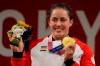 Maude Charron of Canada celebrates her gold medal on the podium of the women's 64kg weightlifting event, at the 2020 Summer Olympics, Tuesday, July 27, 2021, in Tokyo, Japan. THE CANADIAN PRESS/AP/Luca Bruno