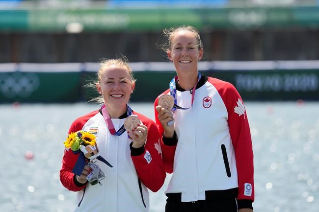 Caileigh Filmer (left) and Hillary Janssens of Canada pose with their bronze medals during the medal ceremony for the women's rowing pair final at the 2020 Summer Olympics, Thursday, July 29, 2021, in Tokyo, Japan. THE CANADIAN PRESS/AP/Lee Jin-man