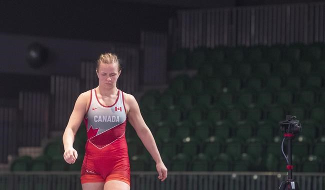Empty seats provide the background as Canadian wrestler Erica Wiebe steps on to the wrestling mat for competition at the Pan-American qualifier, in Ottawa, Saturday, March 14, 2020. Wiebe will enter the women's 76-kilogram wrestling event as a reigning Olympic champion when competition kicks off Sunday at the Makuhari Messe Hall in Chiba, about 50 kilometres outside the Japanese capital. THE CANADIAN PRESS/Adrian Wyld