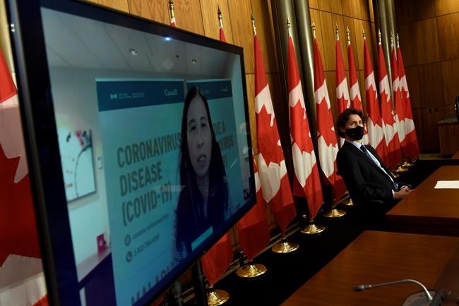 Prime Minister Justin Trudeau listens as Chief Public Health Officer of Canada Dr. Theresa Tam is seen via videoconference during a news conference on the COVID-19 pandemic in Ottawa on Friday, June 4, 2021. Federal officials are warning that Canada could be on the brink of a fourth wave of COVID-19 driven by the highly contagious Delta variant if the country opens too fast before enough people have been vaccinated. THE CANADIAN PRESS/Justin Tang