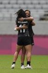 New Zealand's Stacey Fluhler, back, hugs teammate Portia Woodman, after they defeated Fiji in extra time in their women's rugby sevens semifinal match at the 2020 Summer Olympics, Saturday, July 31, 2021 in Tokyo, Japan. (AP Photo/Shuji Kajiyama)