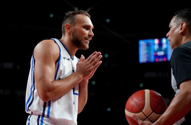 Italy's Stefano Tonut (7), left, interacts with the referee during men's basketball preliminary round game between Italy and Nigeria at the 2020 Summer Olympics, Saturday, July 31, 2021, in Saitama, Japan. (AP Photo/Charlie Neibergall)