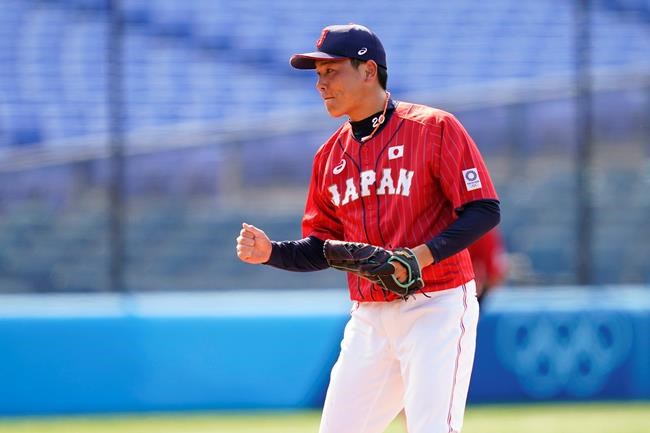Japan's Ryoji Kuribayashi reacts after Japan won a baseball game against Mexico at Yokohama Baseball Stadium during the 2020 Summer Olympics, Saturday, July 31, 2021, in Yokohama, Japan. (AP Photo/Matt Slocum)