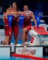 Canada's Maggie Mac Neil, left to right, Sydney Pickrem, Kylie Masse and Penny Oleksiak, in the water, celebrate a bronze medal in the women's 4 x 100m medley relay final during the Tokyo Summer Olympic Games, in Tokyo, Sunday, August 1, 2021. THE CANADIAN PRESS/Adrian Wyld